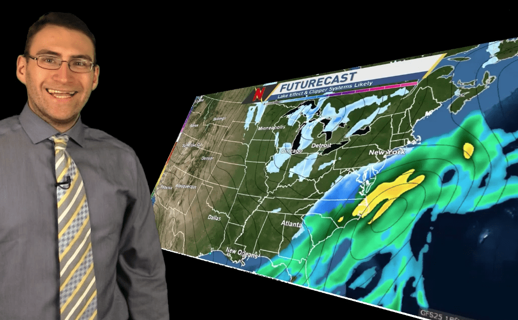 Brian Ivey standing next to a weather map.